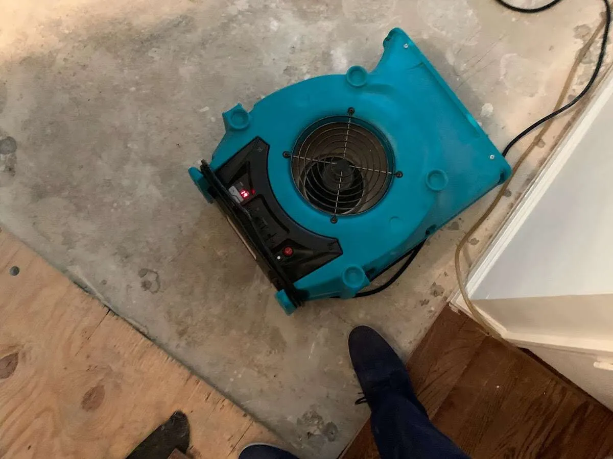 Air mover drying subfloor during Commercial Water Damage Restoration in Lauderhill
